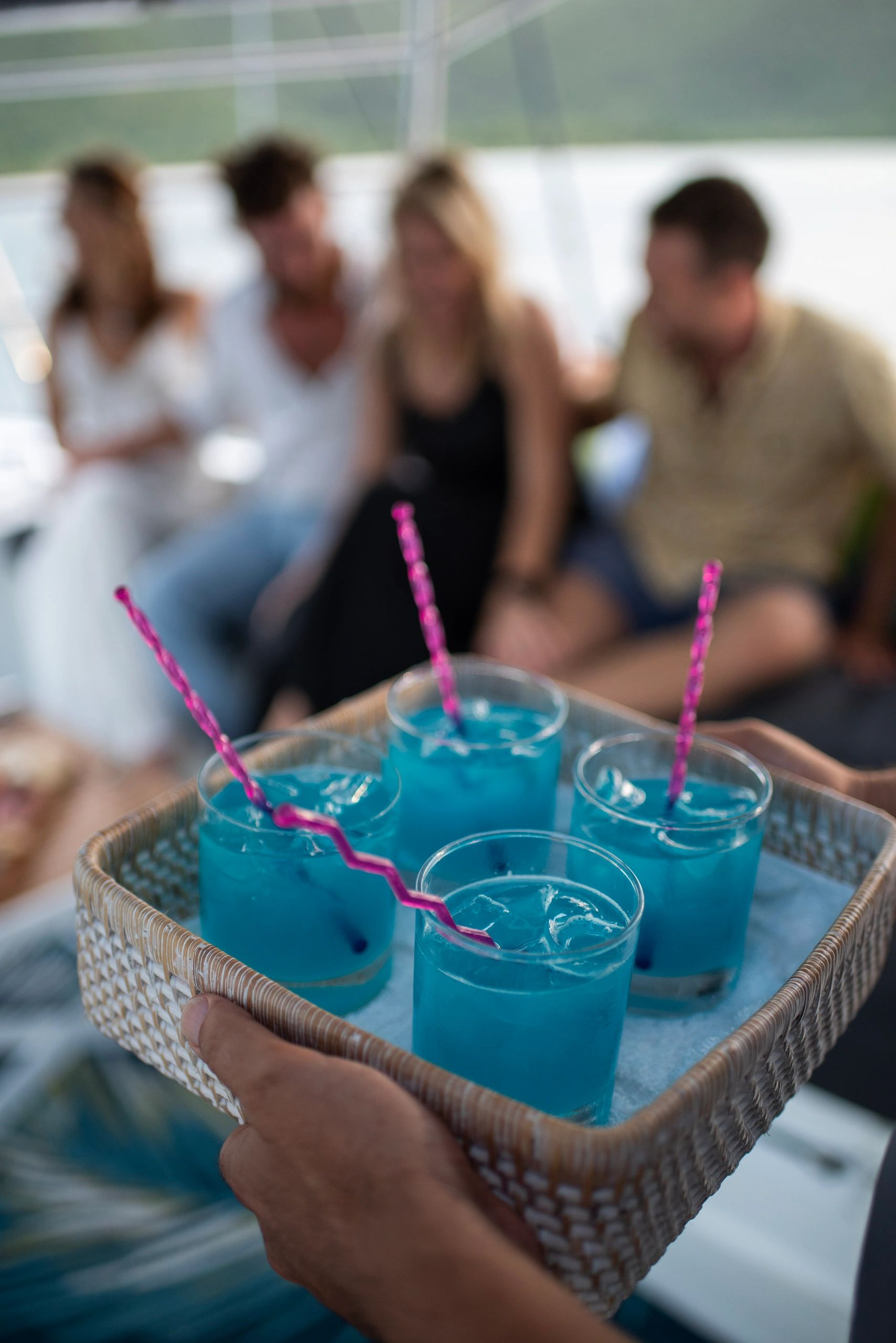 Handcrafted cocktails with pink straws served to guests on Ripple
