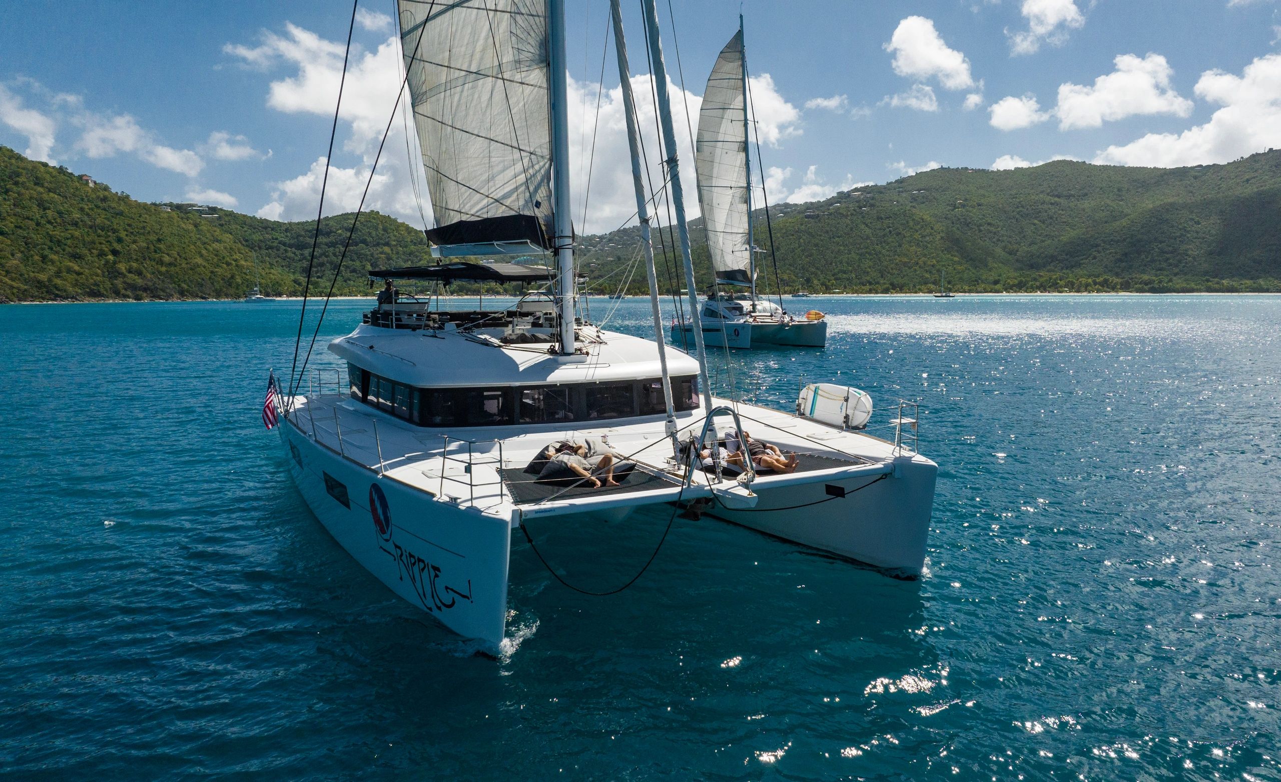 Ripple catamaran sailing with full sails in turquoise Caribbean waters